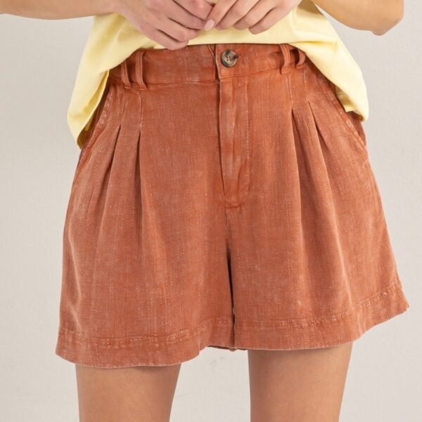 Close-up shot showing the mineral washed fabric and pleats of the High Waist Pleated Linen Shorts