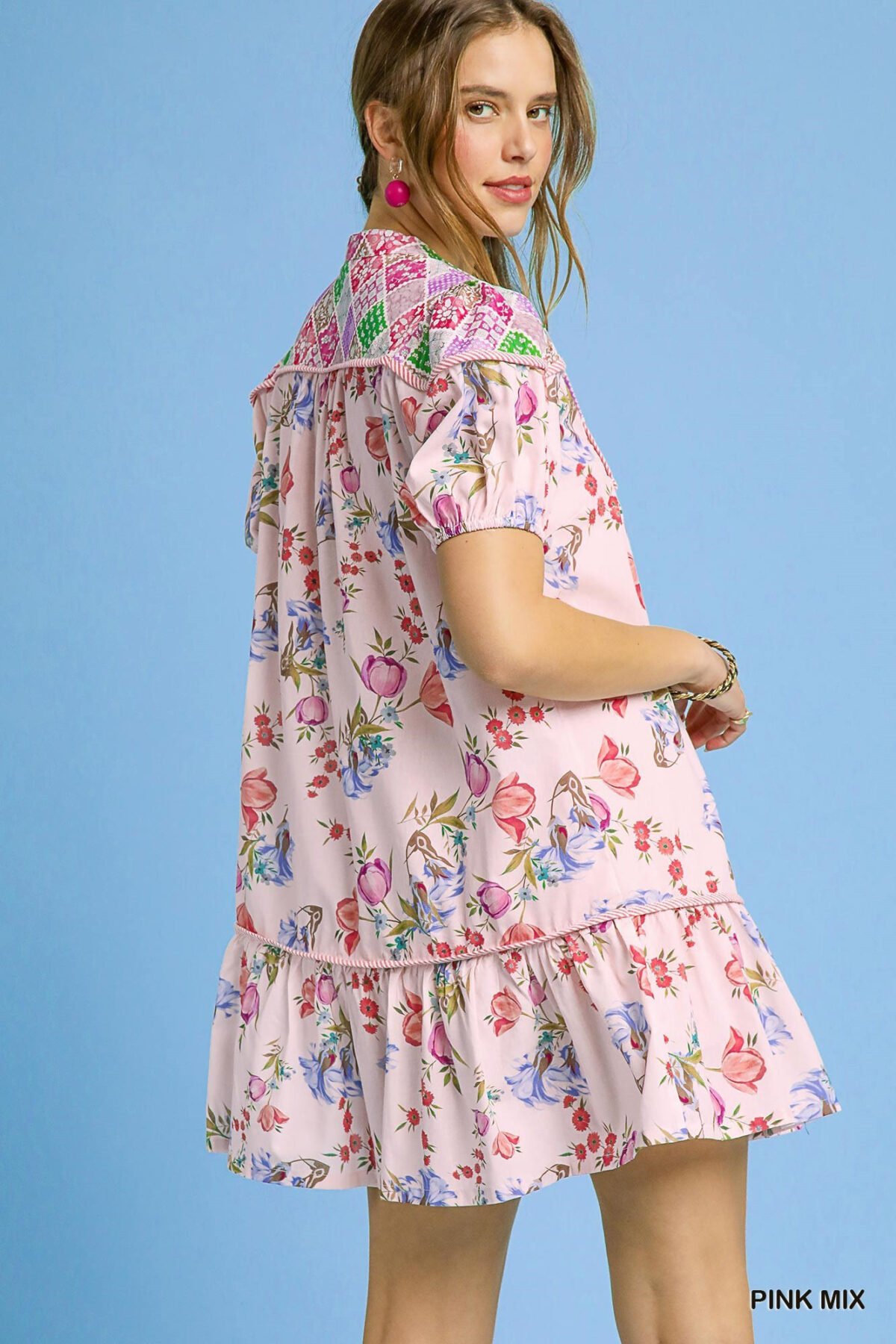 Back view of a floral print dress showing the tie neck and relaxed fit