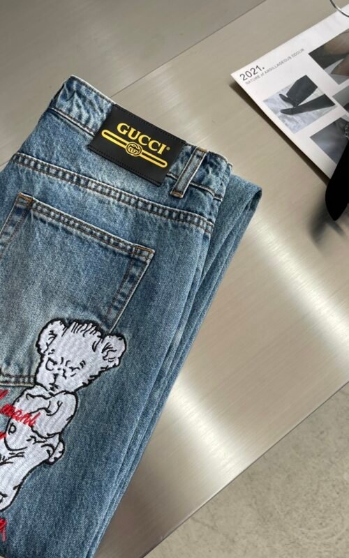 A back shot of the model wearing the Gucci Distressed Jeans, showing how the pants fit and the back pocket details.
