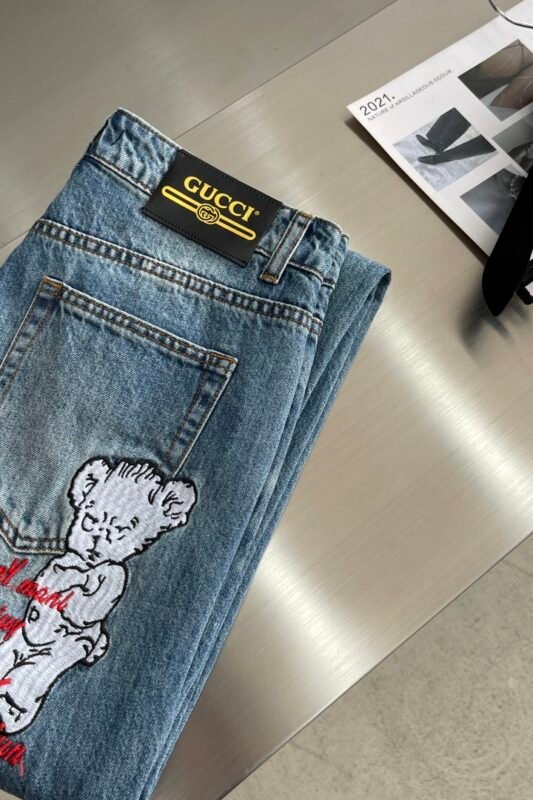A back shot of the model wearing the Gucci Distressed Jeans, showing how the pants fit and the back pocket details.
