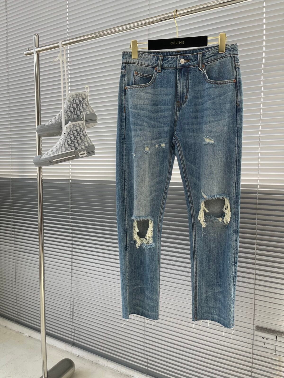 A full-length front view of the Gucci Distressed Jeans, highlighting the washed and ripped details.